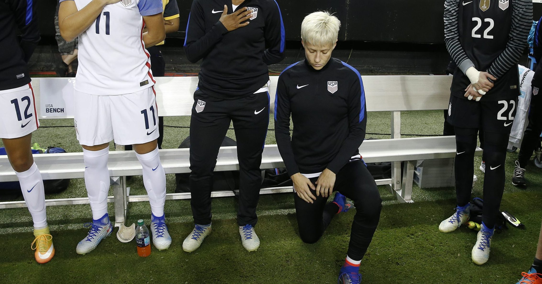 Megan Rapinoe kneels next to her U.S. teammates as the national anthem is played before the team's exhibition soccer match against the Netherlands in Atlanta on Sept. 18, 2016.