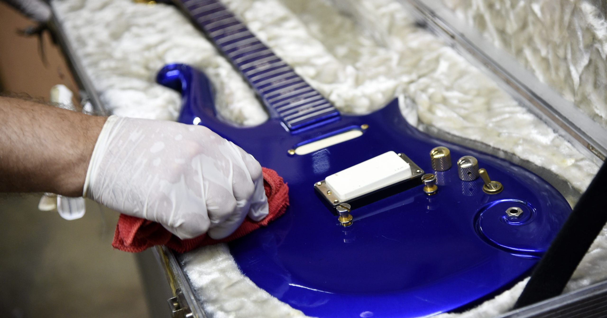 In this May 6, 2020, file photo, the “Blue Angel” Cloud 2 electric guitar custom-made for the musician Prince in the 1980s is polished at Julien's Auctions warehouse in Culver City, California. On June 19, 2020, the instrument shot past the top estimate of $200,000 it was expected to fetch at the Music Icons sale at the auction house.