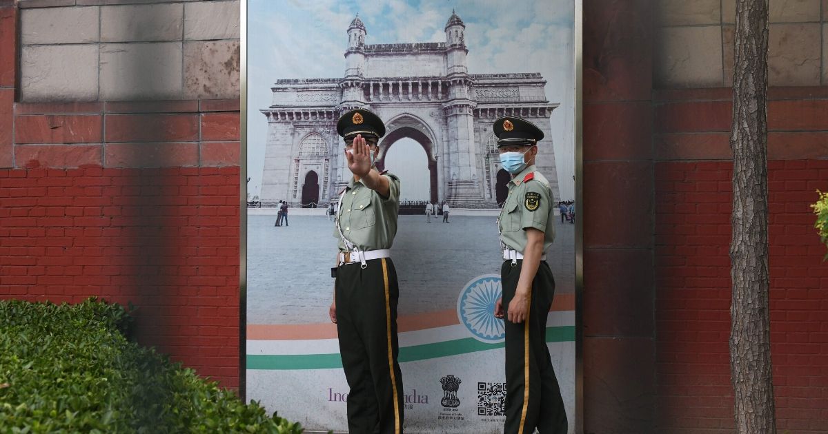 Two Chinese paramilitary police officers patrol outside the Indian embassy in Beijing on June 16, 2020. China on June 16 accused India of crossing a disputed border between the two countries, as the Indian army said three of its soldiers had been killed in violent clashes.
