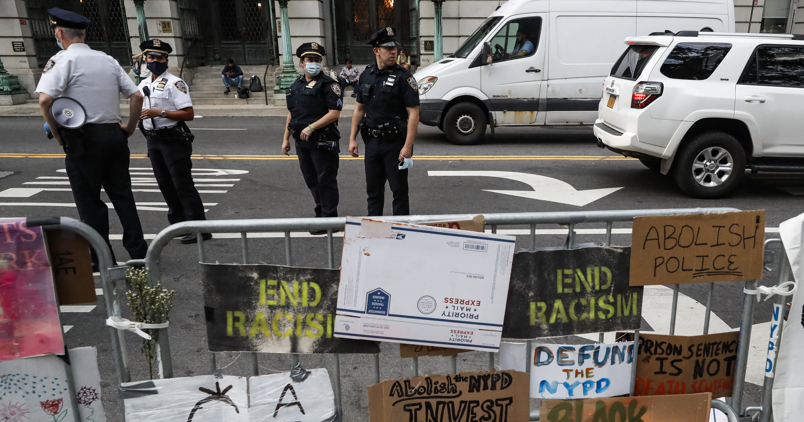 Police stand on the street beside a protest encampment outside City Hall on June 26, 2020, in New York City.