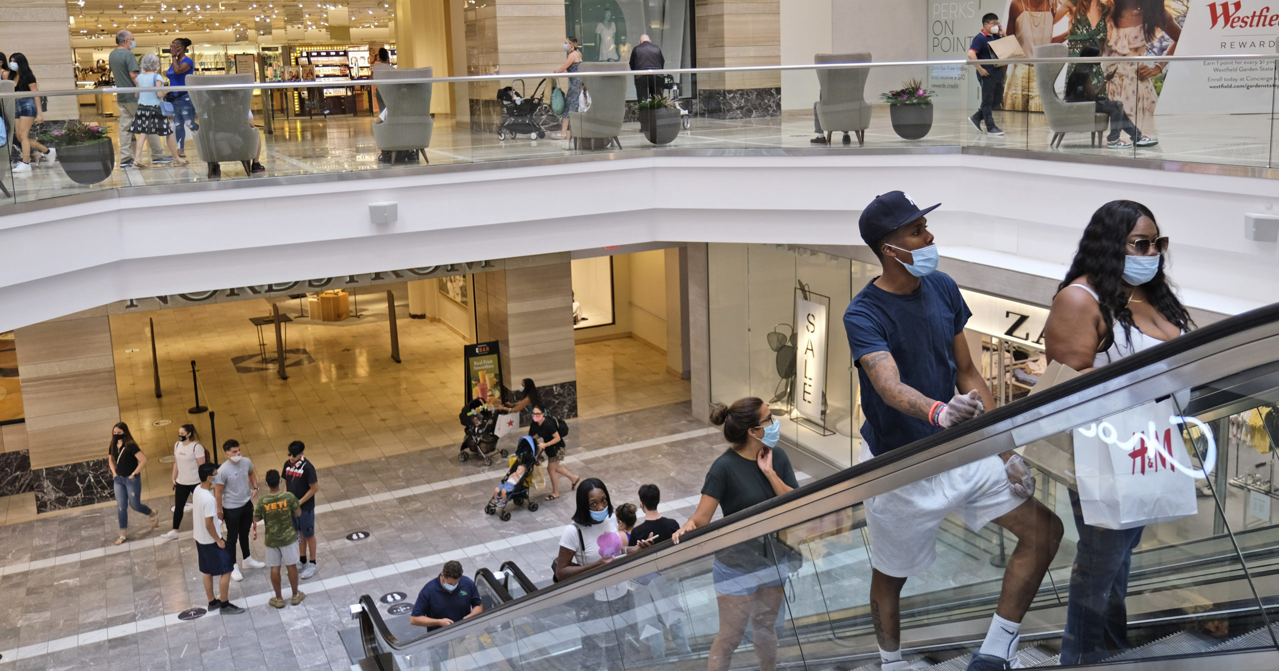 In this June 29, 2020, file photo, shoppers move about in Garden State Plaza in Paramus, New Jersey. U.S. consumer confidence rose to 98.1 in June, reflecting the partial re-opening of the country.