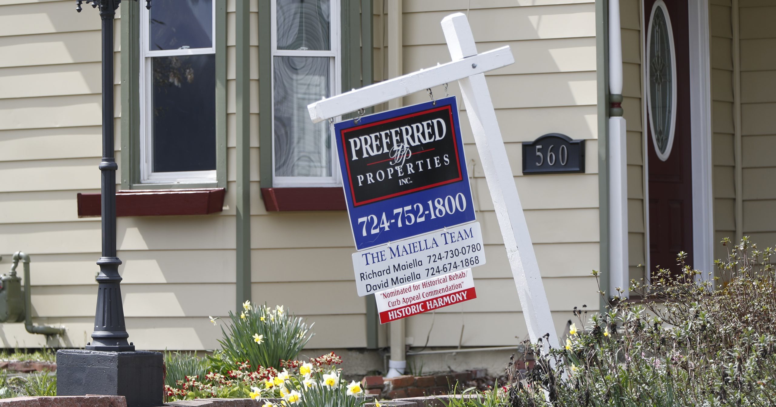 This April 16, 2020, photo shows a real estate company sign that marks a home for sale in Harmony, Pennsylvania.