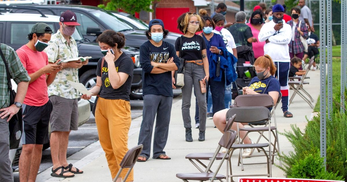 Voters wait in a line that stretched around the Metropolitan Library in Atlanta on June 9, 2020.