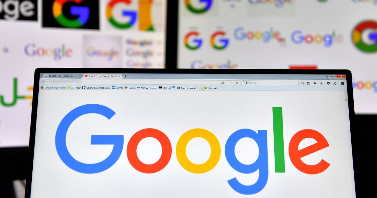 A picture taken on Nov. 20, 2017, shows Google logos displayed on computers' screens.