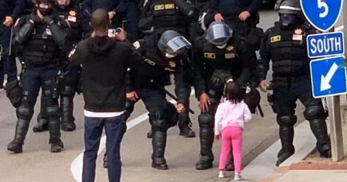 CHP officers talk to a young girl in San Diego.