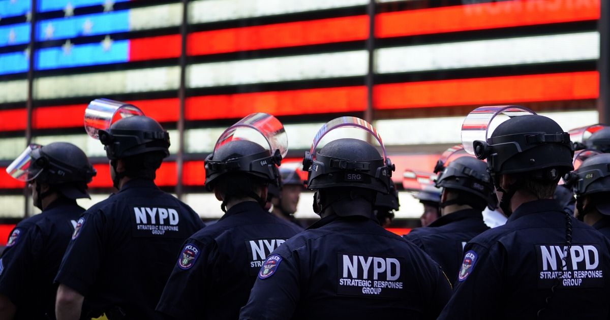 New York police officers watch demonstrators in Times Square on June 1, 2020, during a "Black Lives Matter" protest.
