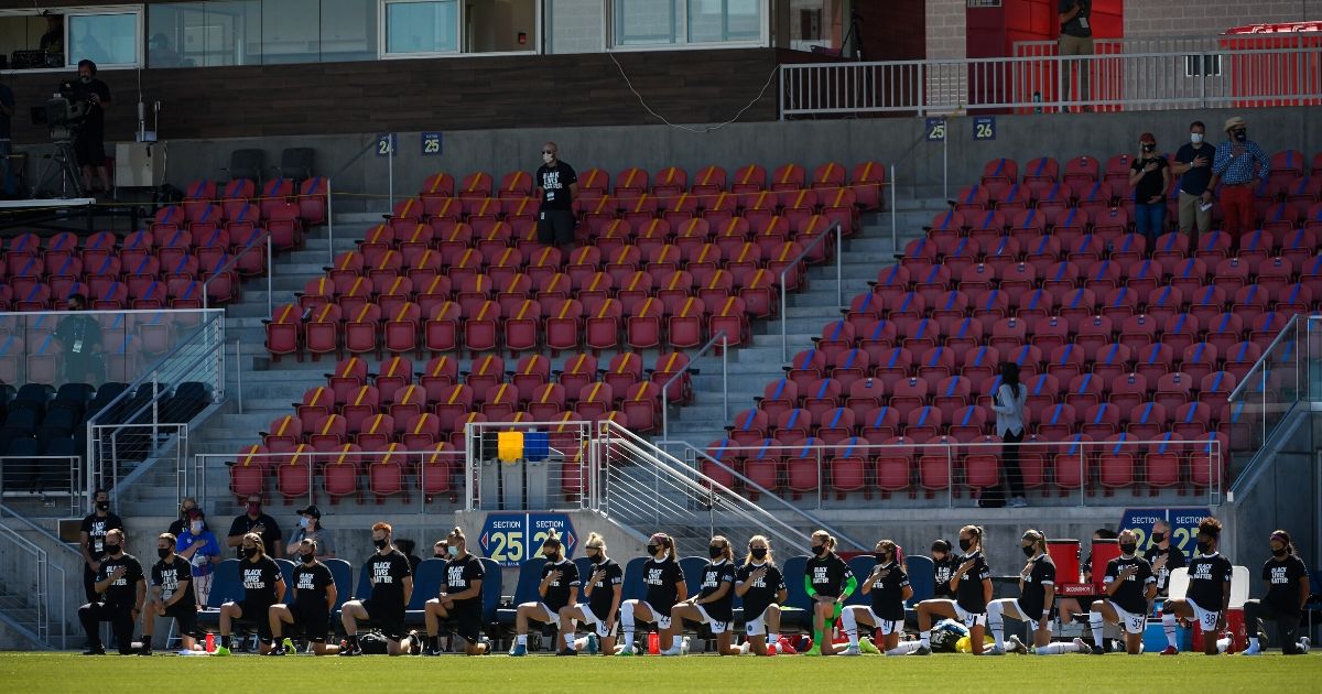 Members of Portland Thorns FC kneel during the national anthem before a game against the North Carolina Courage during the first round of the NWSL Challenge Cup at Zions Bank Stadium on June 27, 2020, in Herriman, Utah.