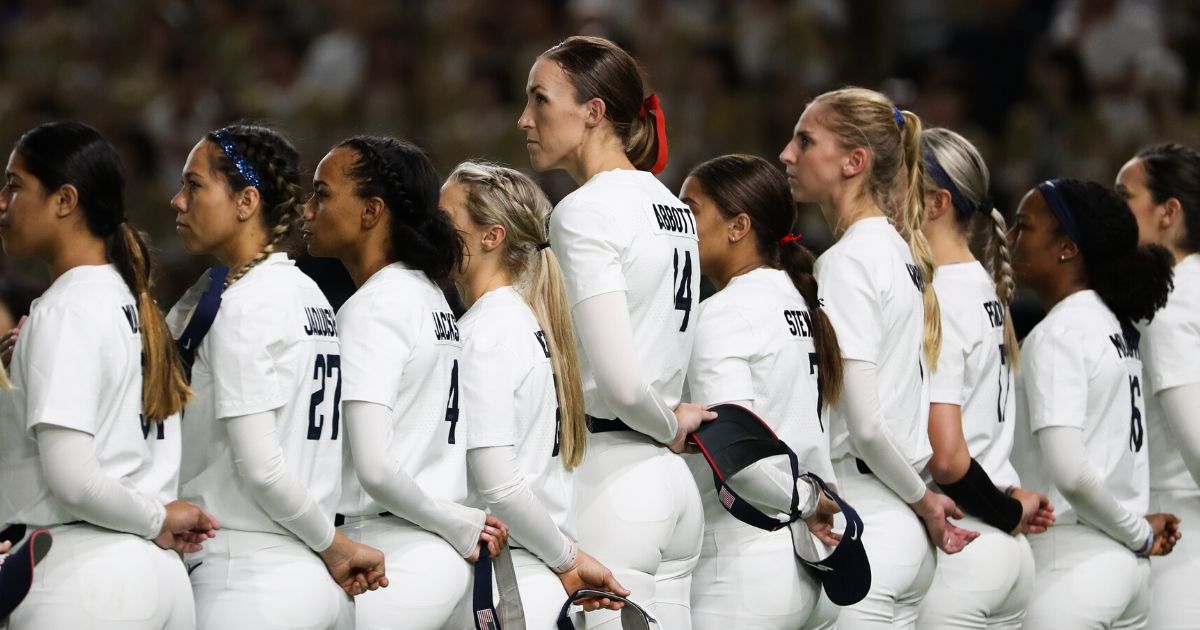 Players stand during the national anthem prior to a softball game between Japan and the United States at the Tokyo Dome on June 25, 2019, in Tokyo, Japan.