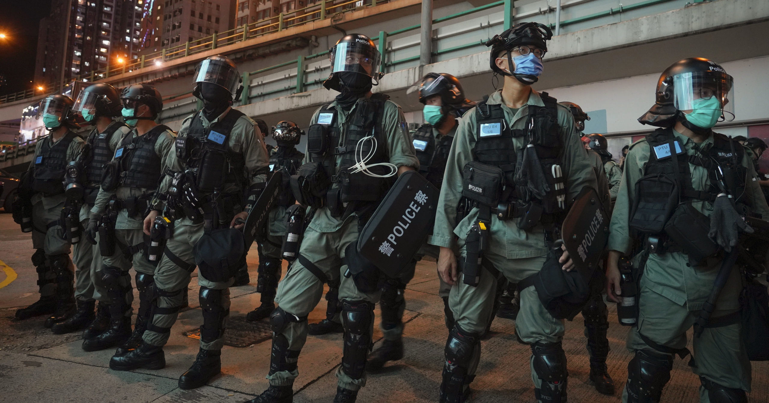 Riot police stand guard at a protest against the new security law during the anniversary of the Hong Kong handover from Britain on July 1, 2020, in Hong Kong. Hong Kong police have made their first arrests under a new national security law imposed by mainland China. The law, which took effect Tuesday night, makes activities deemed subversive or secessionist punishable by up to life in prison.