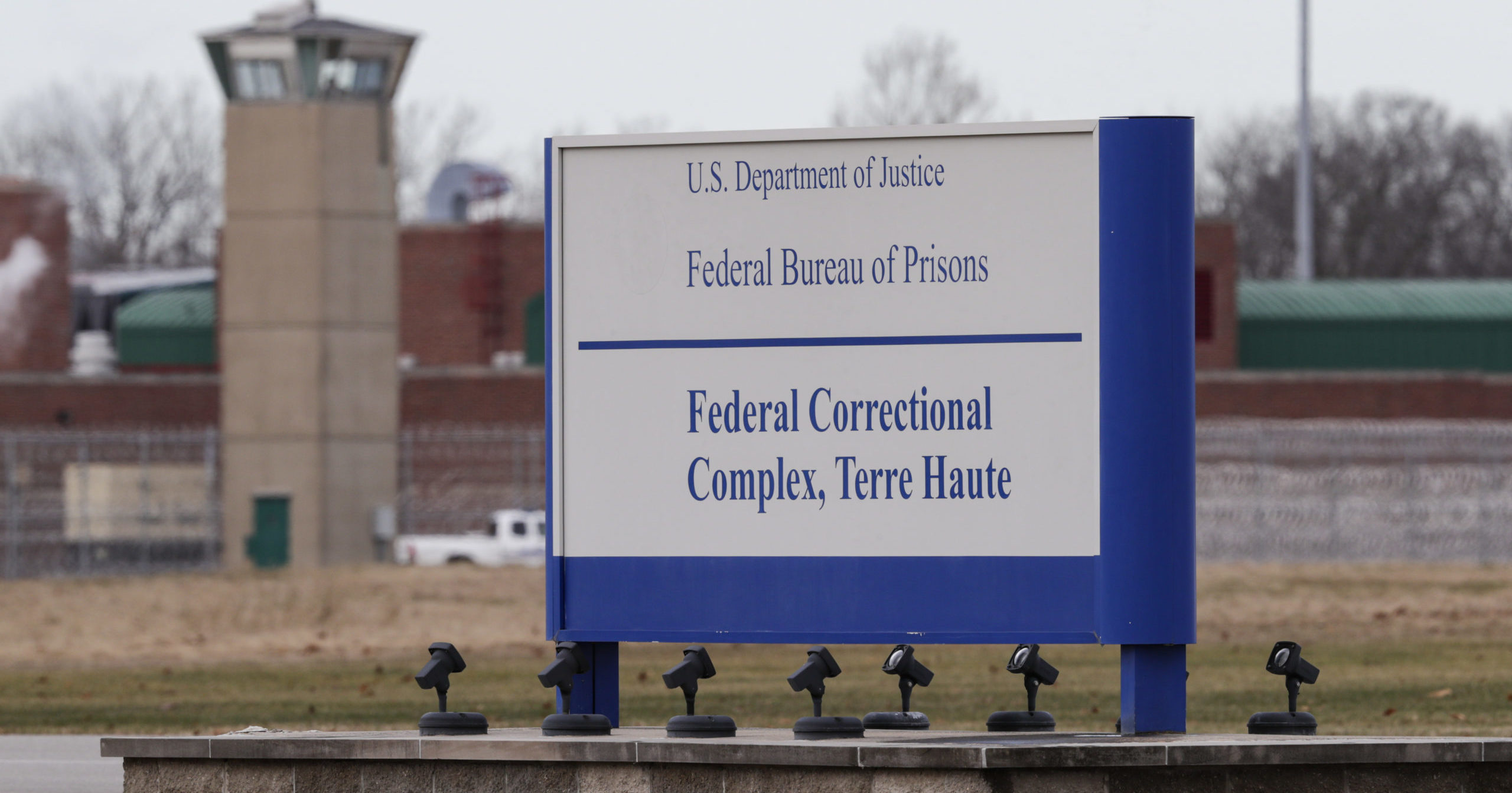 In this Dec. 10, 2019, file photo, the guard tower flanks the sign at the entrance to the U.S. Penitentiary in Terre Haute, Indiana.