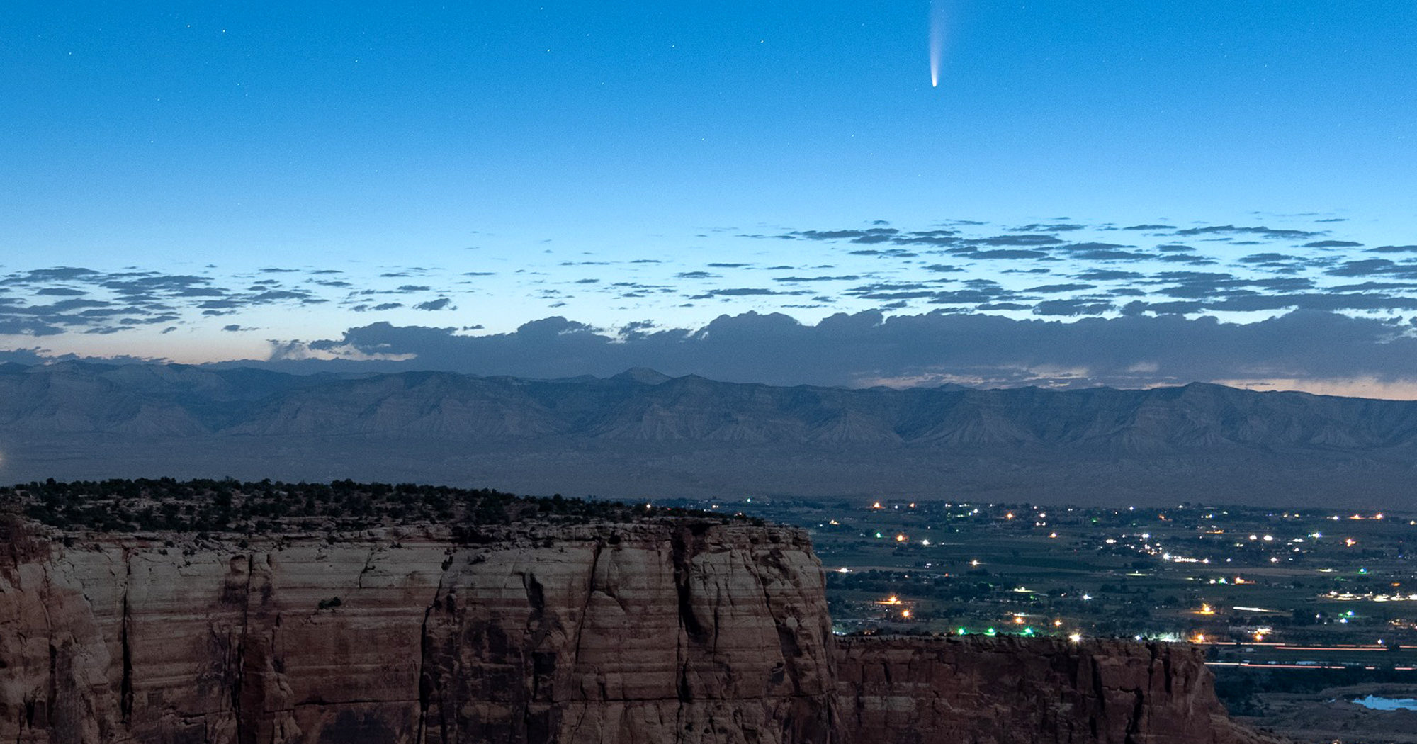 Comet Neowise soars in the horizon of the early morning sky in this view from the Colorado National Monument west of Grand Junction, Colorado, on July 9, 2020.