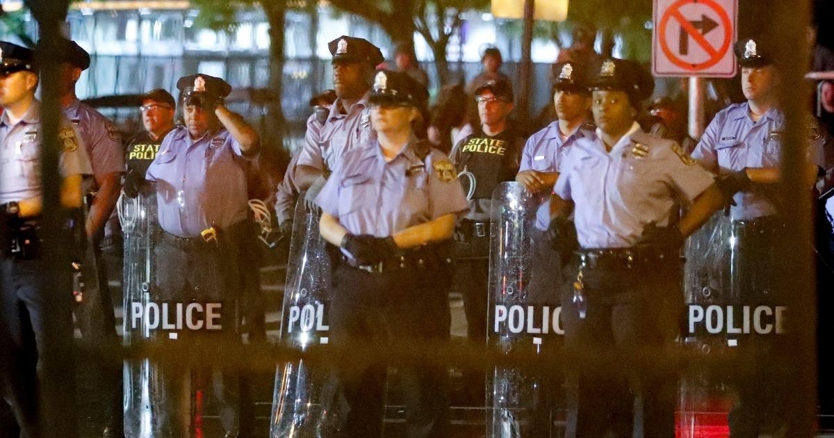 Police watch during a protest at Franklin Delano Roosevelt park in Philadelphia on July 28, 2016, during the final day of the Democratic National Convention.