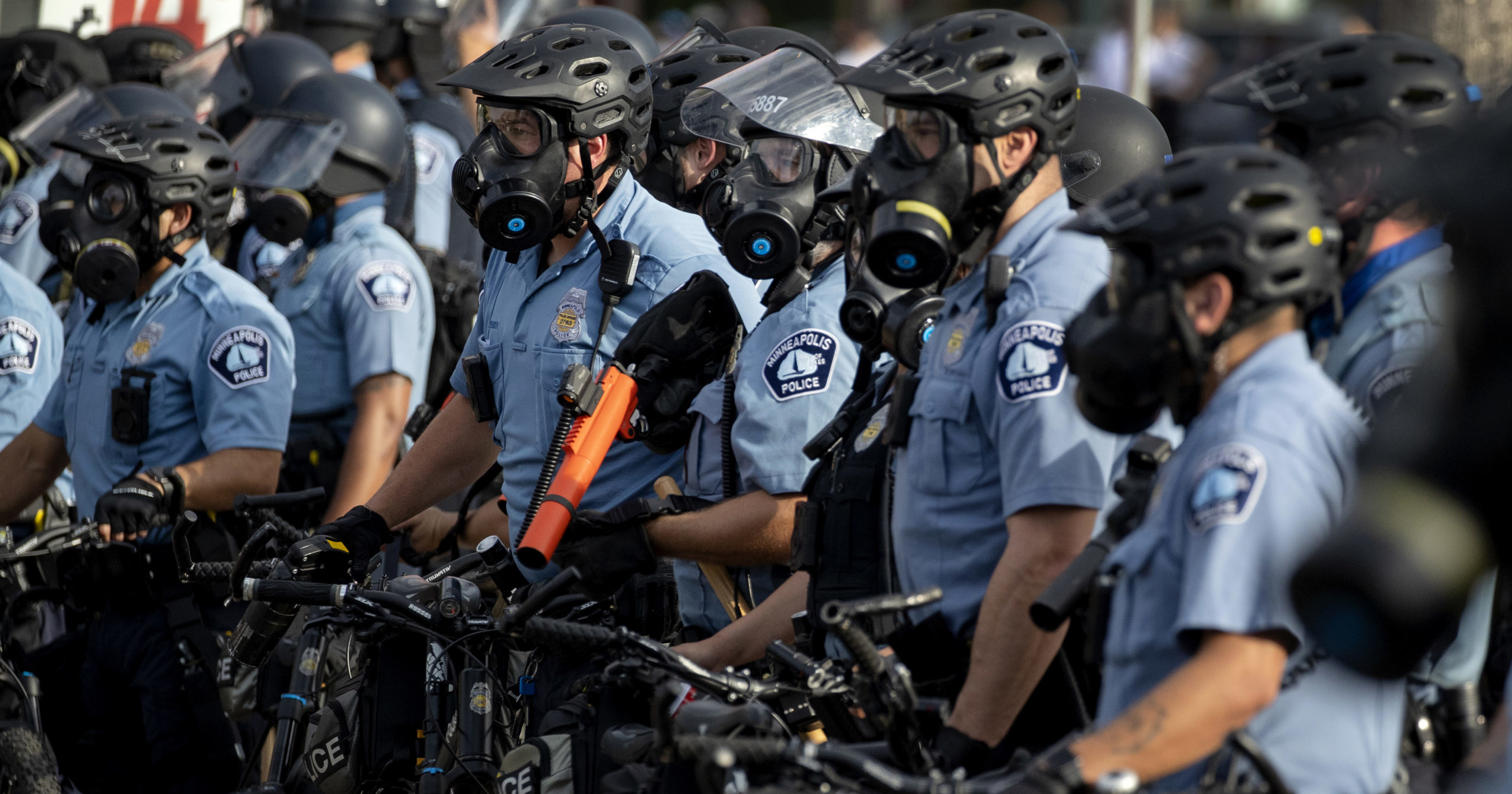 In this May 27, 2020, file photo, police gather as protests continue at the Minneapolis 3rd Police Precinct in Minneapolis. More than 150 Minneapolis police officers have started the process of filing for disability claims since the death of George Floyd and the ensuing unrest in the city, with the majority citing post-traumatic stress disorder as the reason for their planned departure, according to an attorney representing the officers.