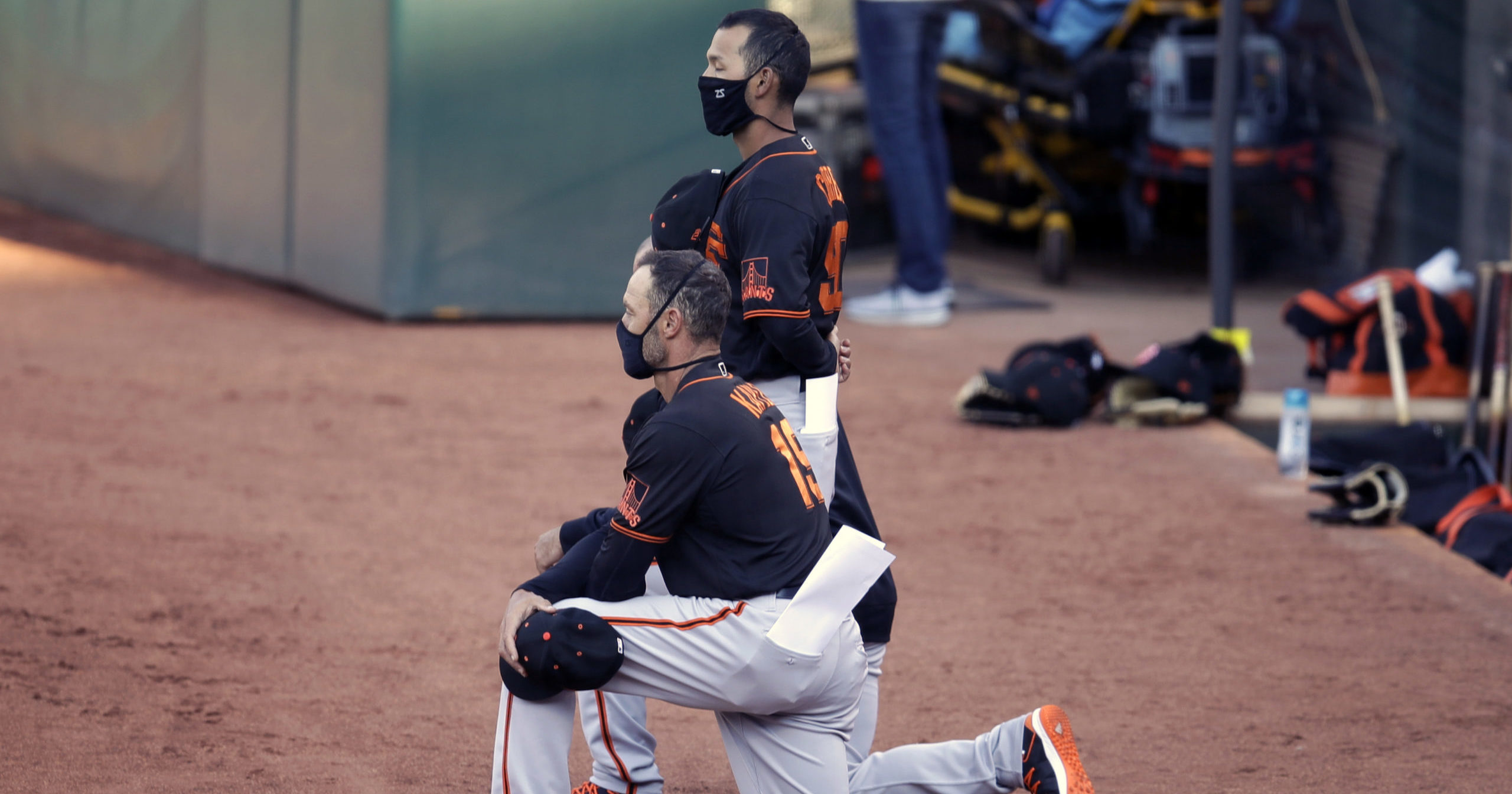 San Francisco Giants manager Gabe Kapler kneels during the national anthem prior to an exhibition baseball game against the Oakland Athletics on July 20, 2020, in Oakland, California.