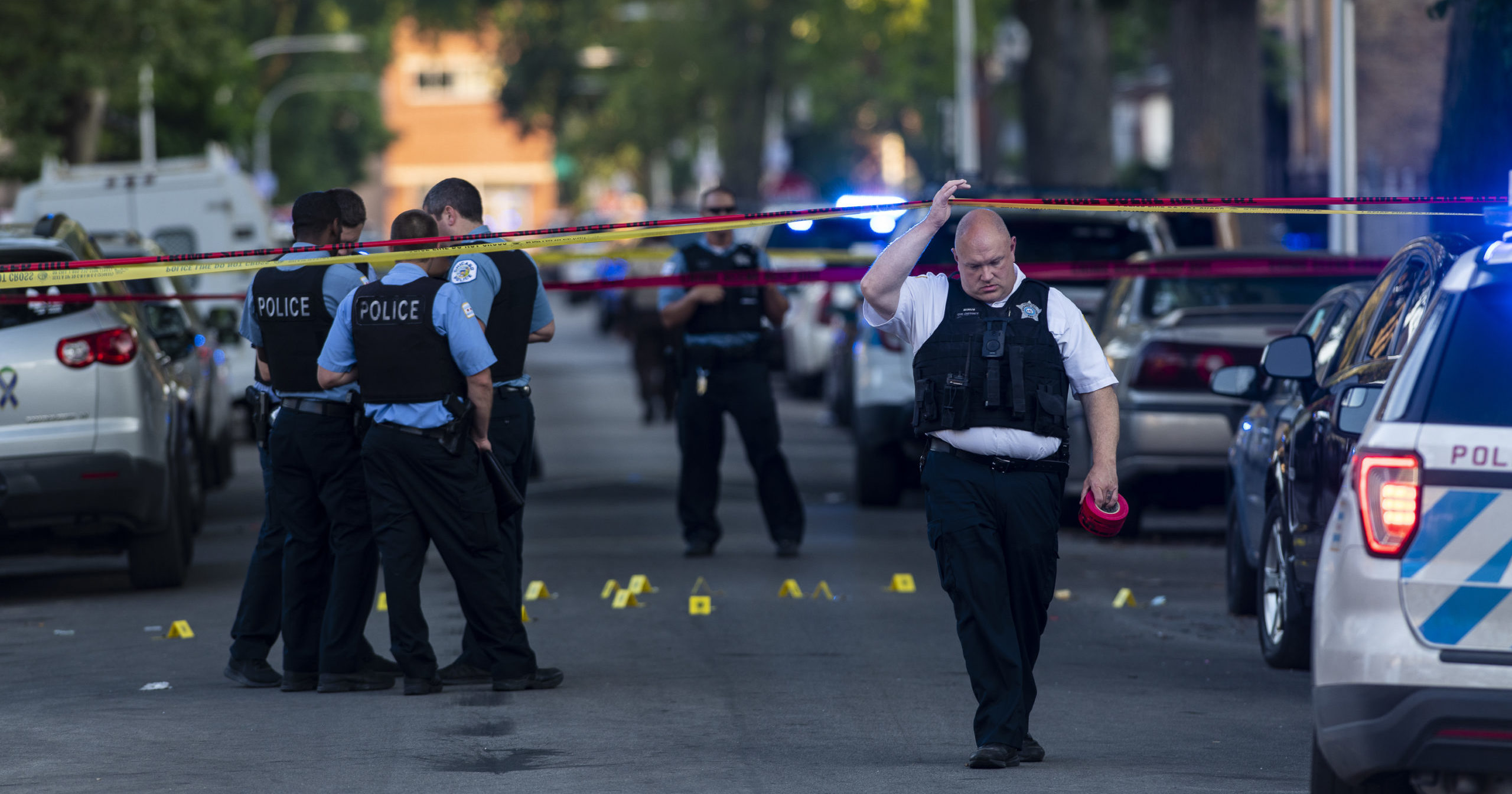 Chicago police officers investigate the scene of a deadly shooting July 5, 2020, in which a 7-year-old girl and a man were fatally shot during a Fourth of July party.