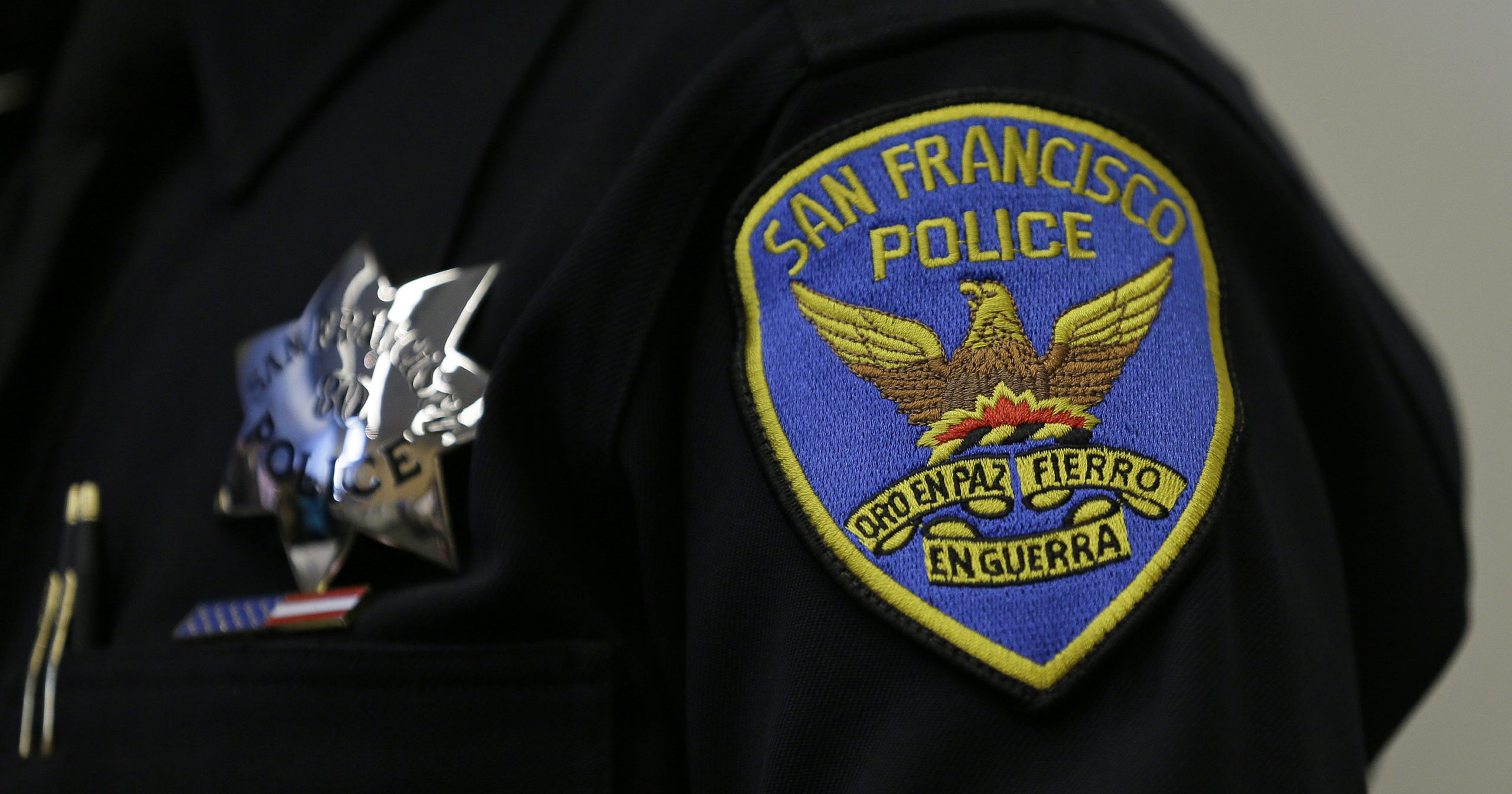 This April 29, 2016, file photo shows a patch and badge on the uniform of a San Francisco police officer. The San Francisco Police Department will stop releasing mug shots in an effort to stop perpetuating racial stereotypes, the police chief announced on July 1, 2020.