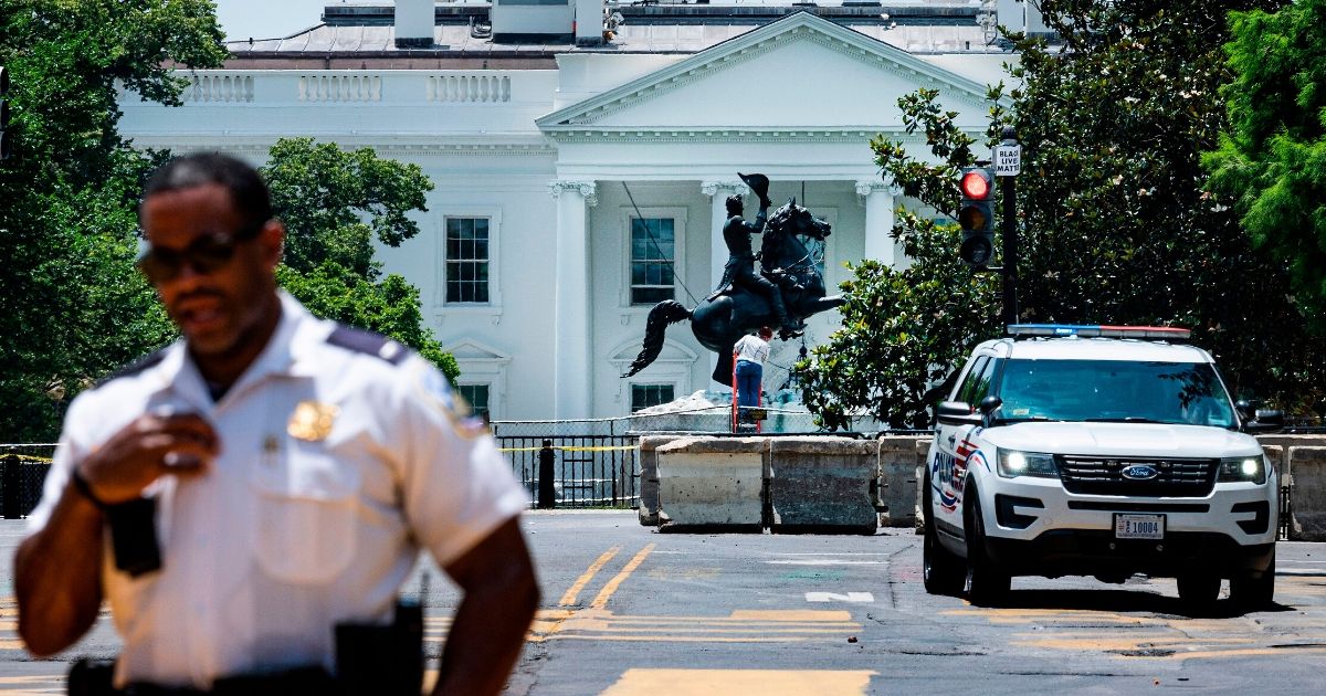 The statue of former President Andrew Jackson is inspected after demonstrators tried overnight to tear it down in Lafayette Park in Washington, D.C., on June 23, 2020.