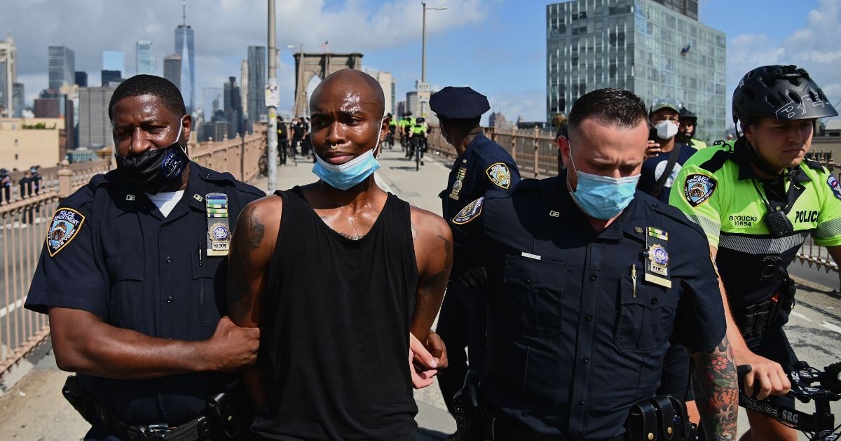 BLM members get arrested on the Brooklyn Bridge during a protest on July 15, 2020, in New York City.