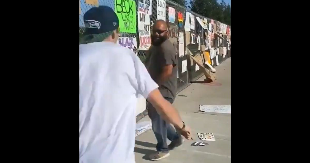 A man charges at a resident of Visalia, California, who's taking down "Black Lives Matter" signs in his neighborhood.