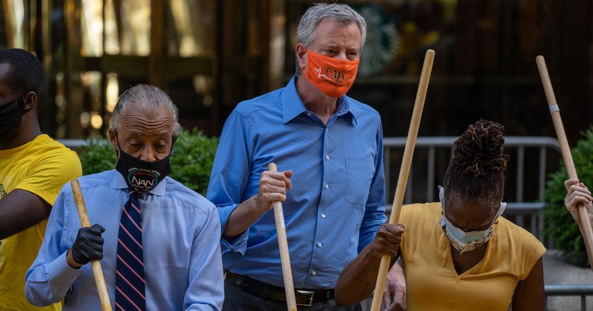 NYC Mayor Bill de Blasio helps paint a Black Lives Matter mural on Fifth Avenue directly in front of Trump Tower on July 9, 2020, in New York City.