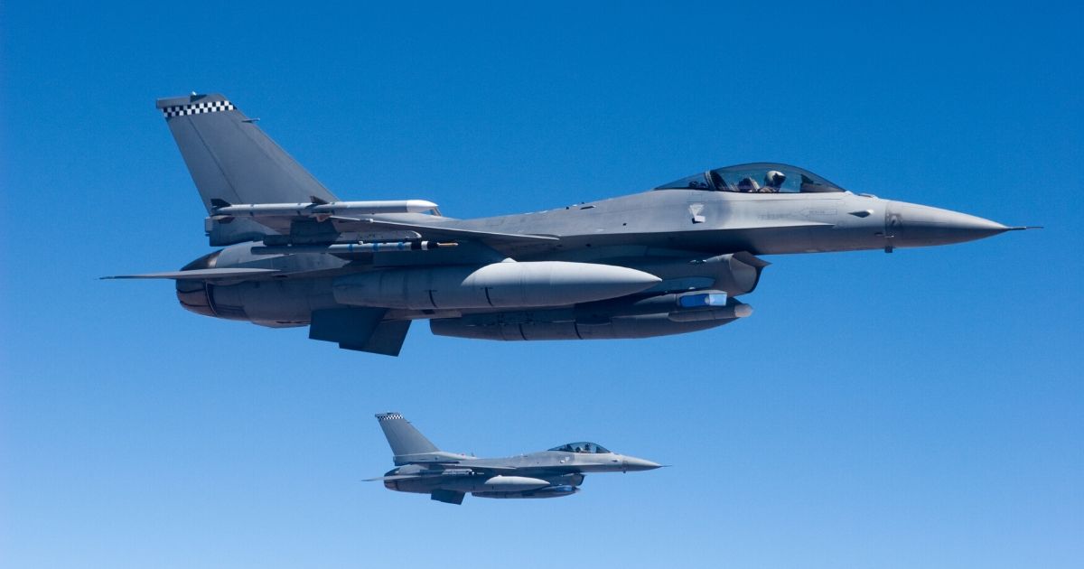 Two F-16 fighter jets fly in formation.