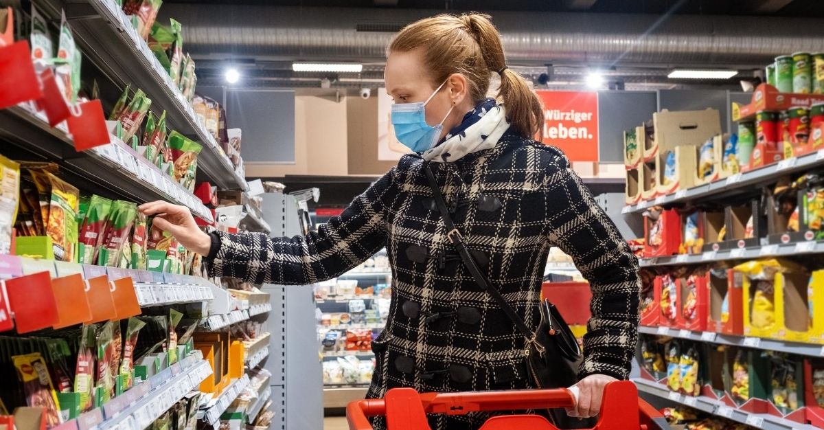 A woman shops for groceries while wearing a mask during the Covid-19 pandemic.
