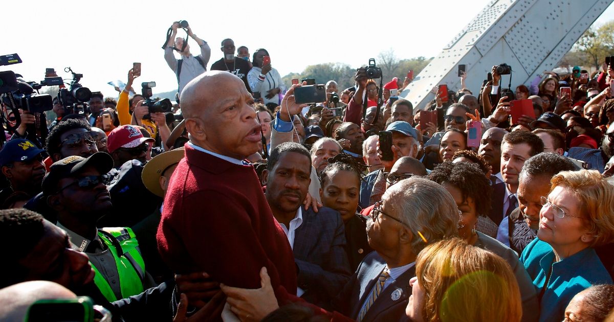 Democratic Rep. John Lewis of Georgia speaks as the Rev. Al Sharpton, Sen. Elizabeth Warren of Massachusetts and others listen during the annual "Bloody Sunday" march across the Edmund Pettus Bridge in Selma, Alabama on March 1, 2020.
