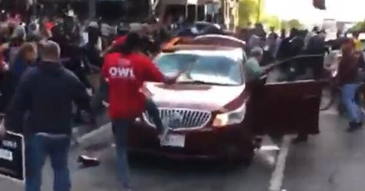 Leftists attacking car.