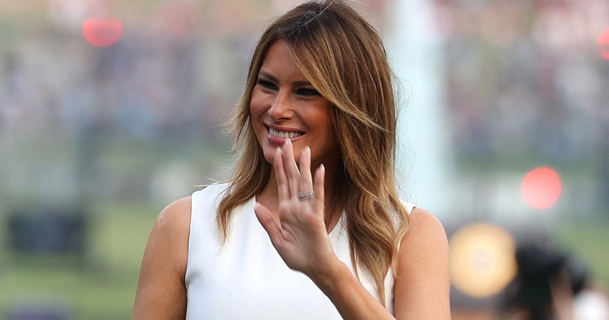 First lady Melania Trump waves to people as she walks along the South Lawn of the White House during an Independence Day event July 4, 2020.