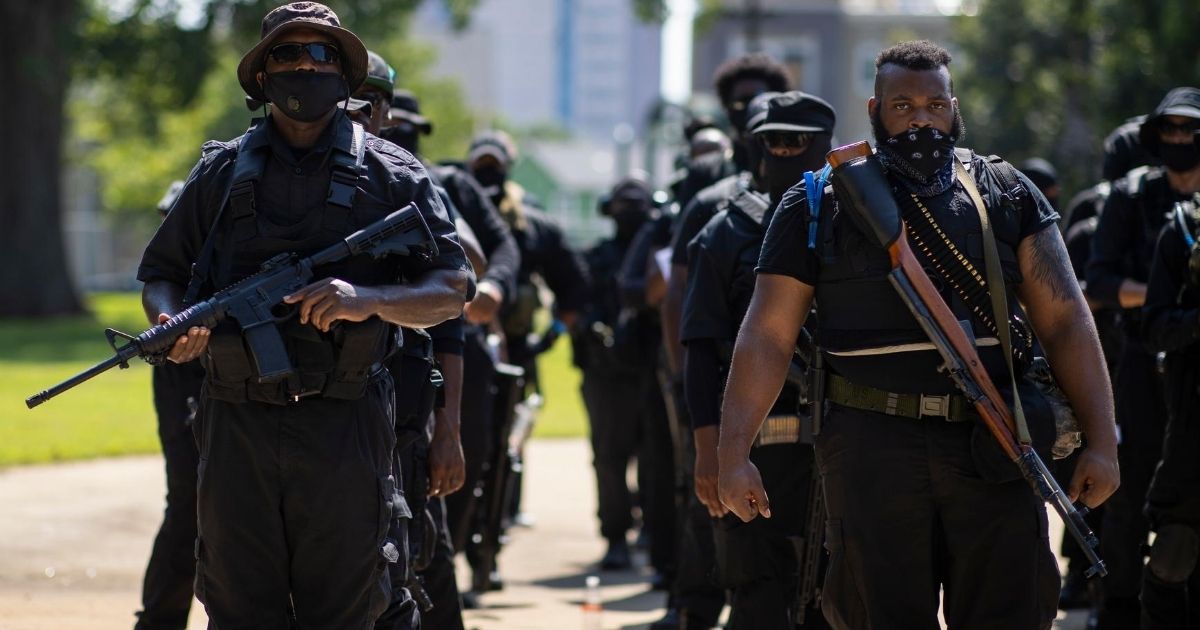 Members of a protester group affiliated with NFAC, most carrying firearms, gather to march on July 25, 2020, in Louisville, Kentucky.