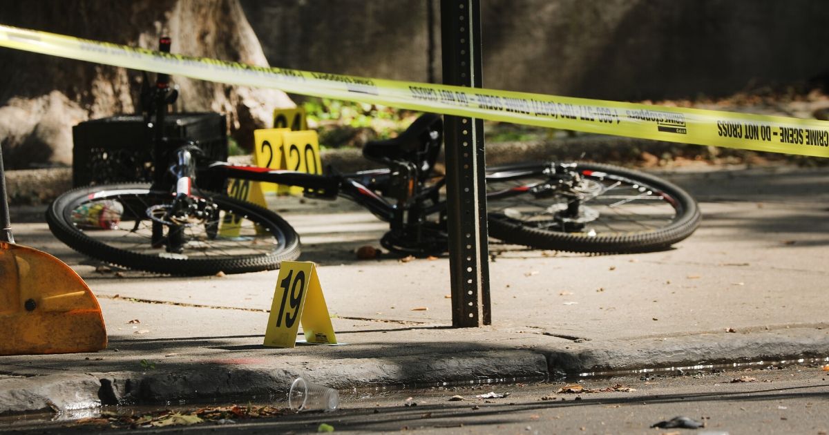 Police ballistic markers stand beside a child's bicycle at a crime scene in Brooklyn, New York, where a 1-year-old boy was shot and killed on July 13, 2020.