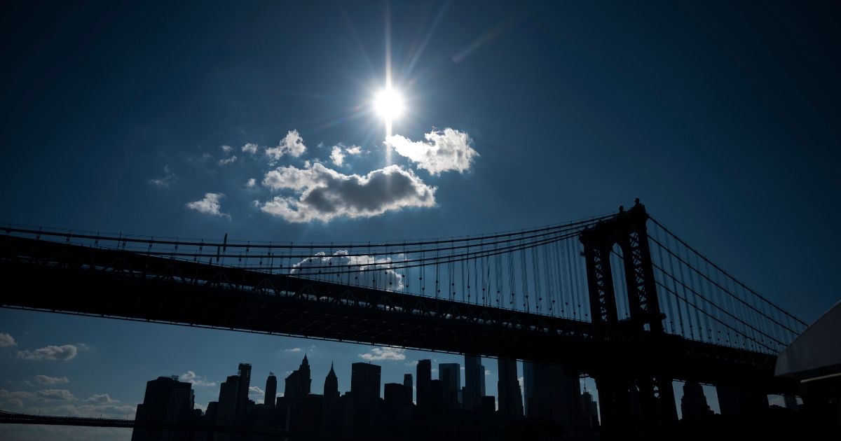 Sun shines above the skyline of Lower Manhattan on July 13, 2020 in New York City.