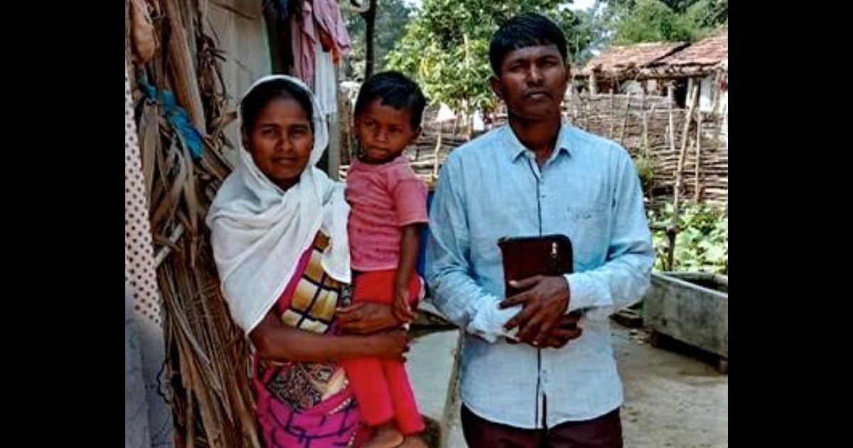 Pastor Munshi Devu Tado with his wife and child.