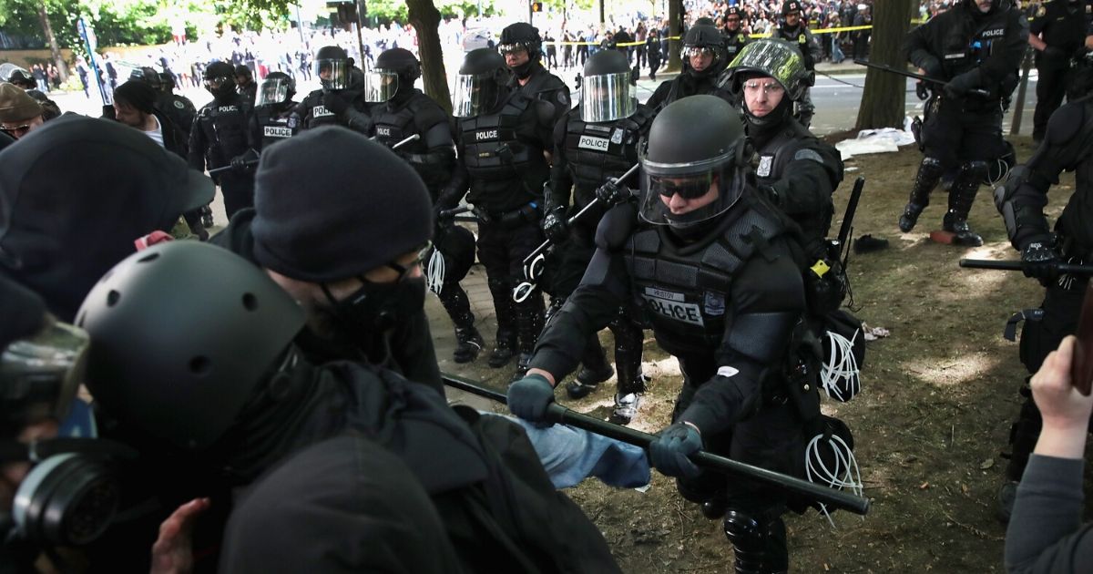 Portland, Oregon police step in on a "Trump Free Speech" on June 4, 2017 to control confrontation between antifascist demonstrators and Trump supporters.
