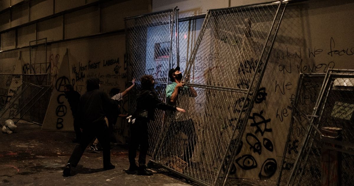 Rioters attempt to barricade the entrance to the Mark Hatfield U.S. Courthouse in Portland, Oregon, on July 17, 2020.