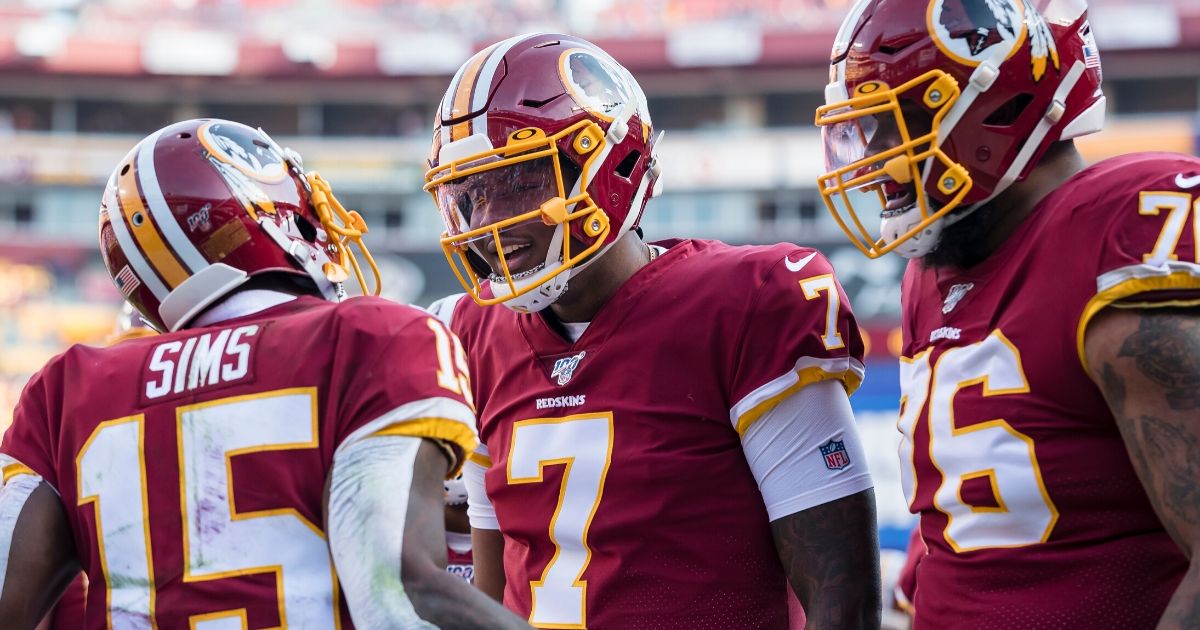 Dwayne Haskins (No. 7) of the Washington Redskins celebrates with Steven Sims (No. 15) after throwing a touchdown pass during the first half of a game against the New York Giants at FedExField in Landover, Maryland, on Dec. 22, 2019.