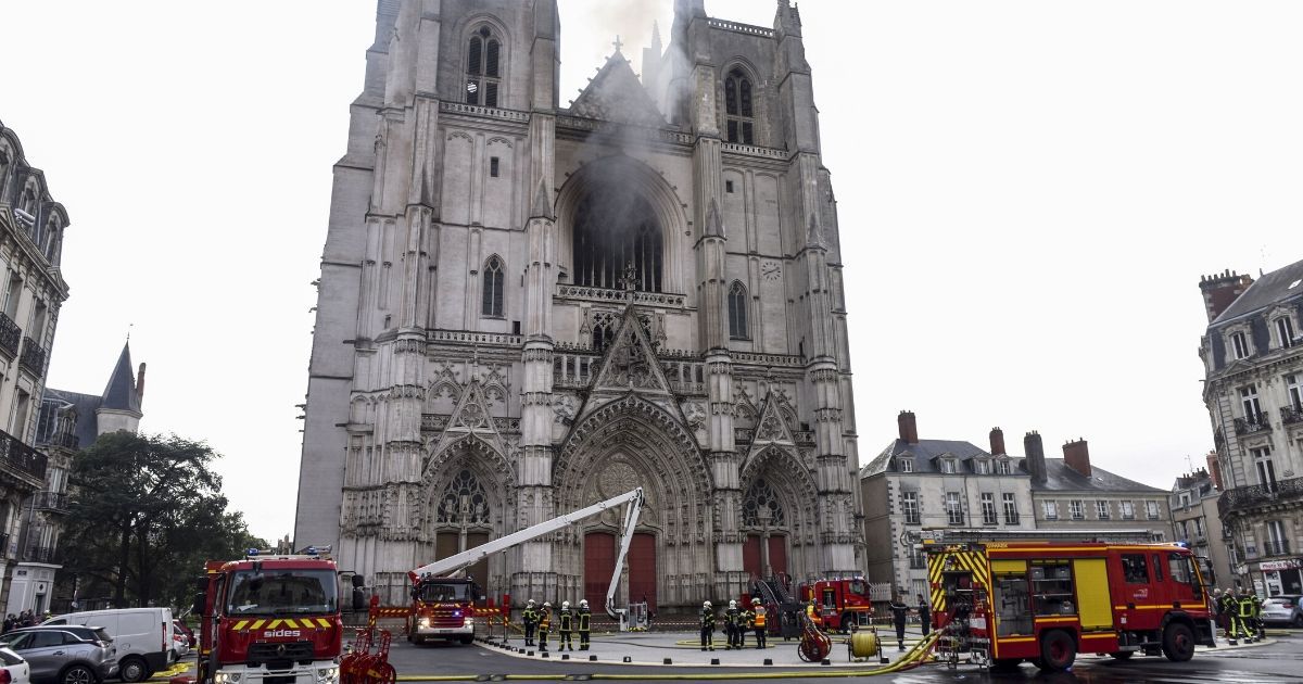 Firefighters work to put out a fire at St, Peter and St. Paul Cathedral in Nantes, France, on Saturday.