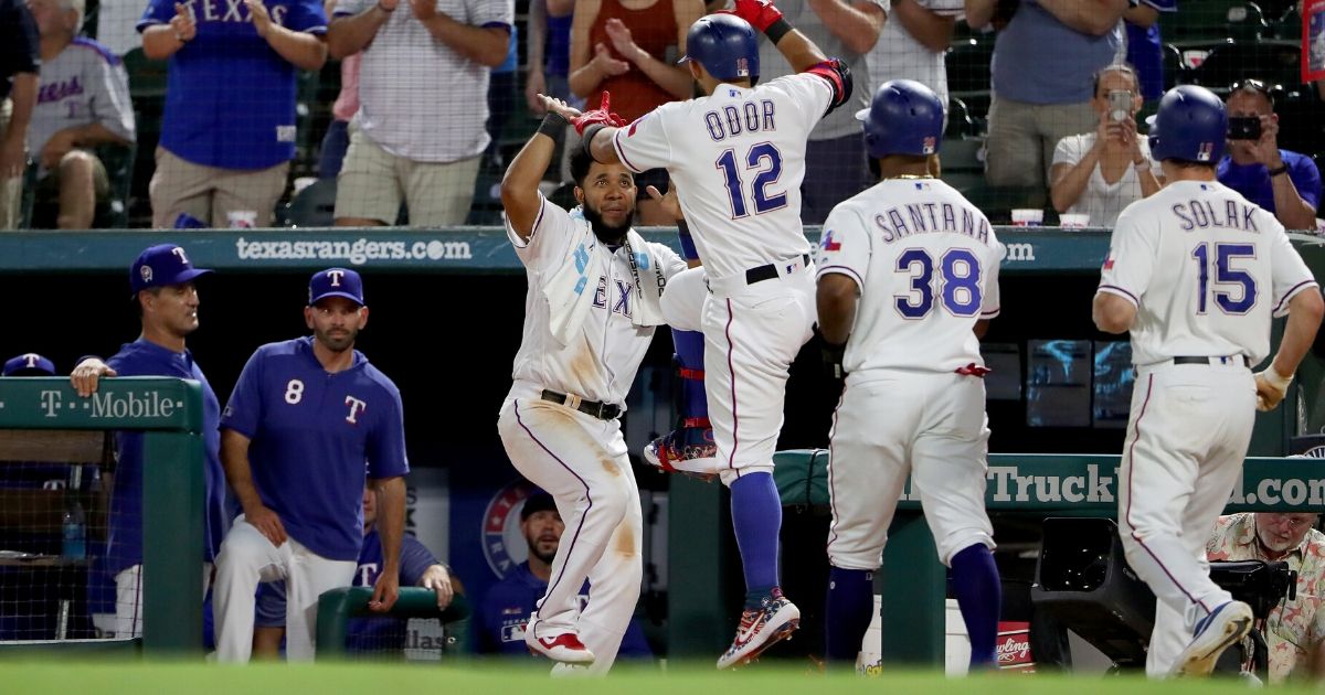 Rougned Odor of the Texas Rangers celebrates with Elvis Andrus after hitting a three-run home run against the Tampa Bay Rays at Globe Life Park in Arlington on Sept. 11, 2019.