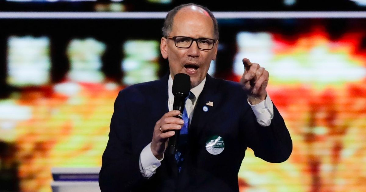 Democratic National Committee Chairman Tom Perez addresses a member of the audience on Feb. 7, 2020, before the start of a Democratic presidential primary debate in Manchester, New Hampshire.