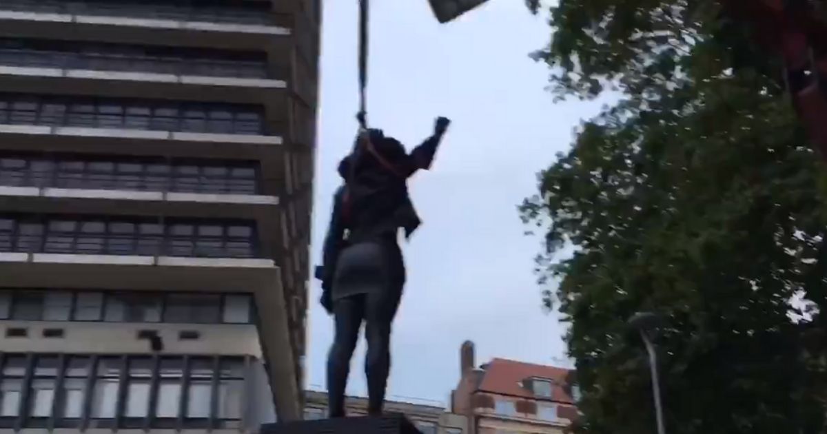 A statue depicting a BLM activist is removed in Bristol, England.
