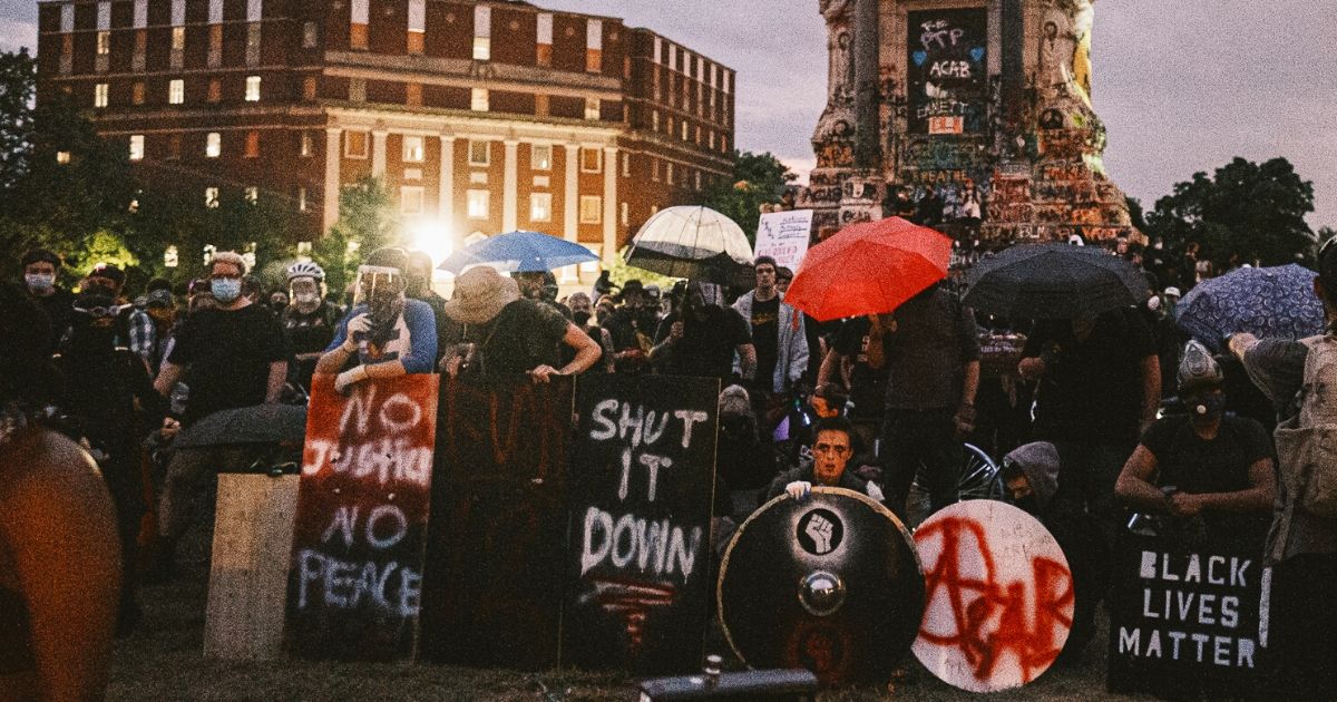 Protesters make a wall with homemade shields and umbrellas on June 23, 2020, in Richmond, Virginia.