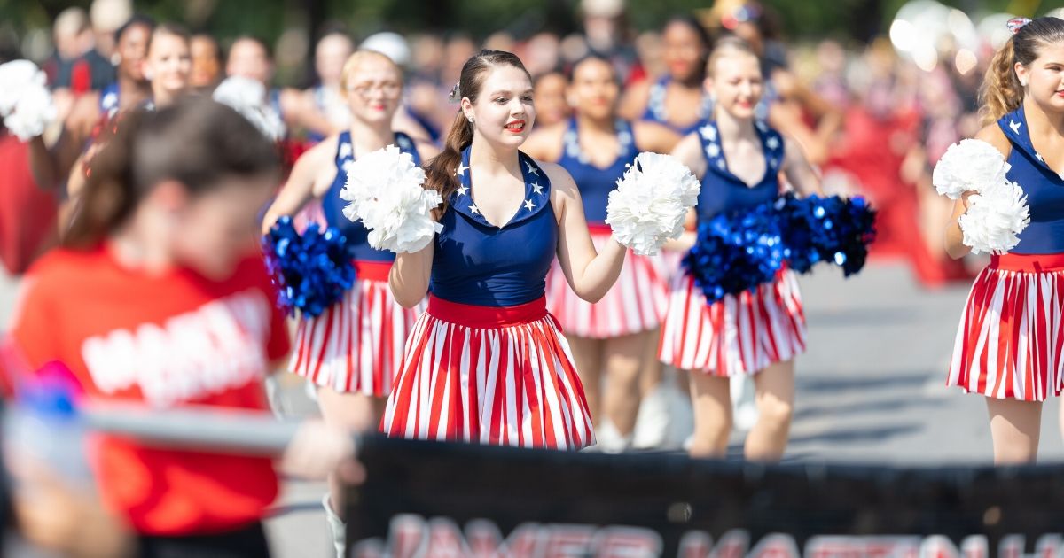 Members of the Sundancers, the dance team of James Martin High School in Arlington, Texas, march in the 2019 Fourth of July Parade in Arlington.