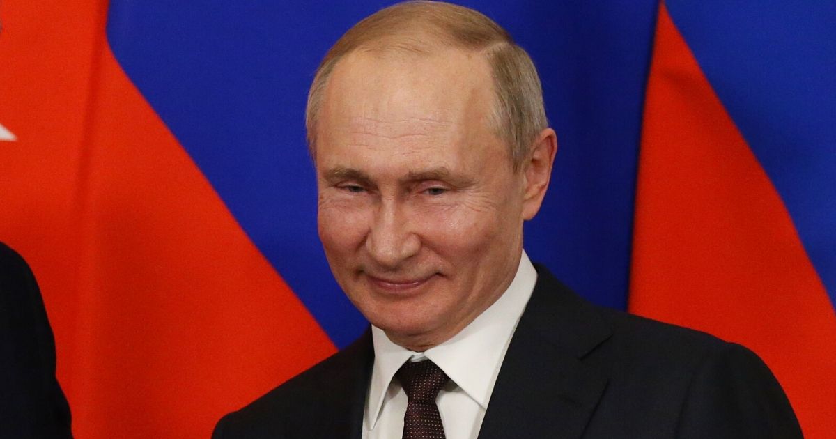 Russian President Vladimir Putin grins in a file photo from March.