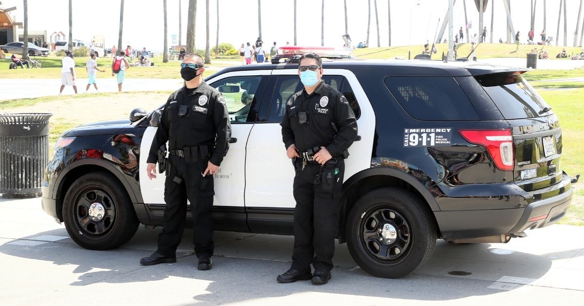Los Angeles Police Department officers wearing protective face masks are seen on May 16, 2020 in Venice, California.