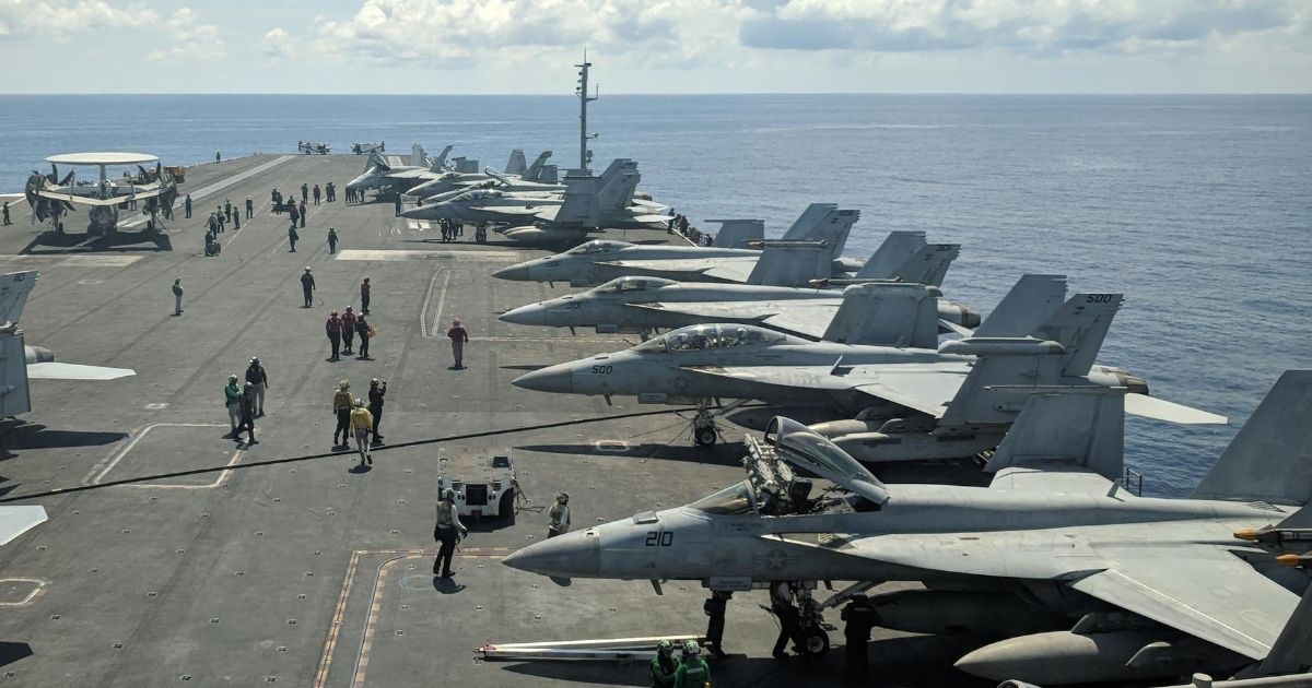This photograph taken on Oct. 16, 2019, shows U.S. Navy F/A-18 Super Hornet multirole fighters and an EA-18G Growler electronic warfare aircraft on board the USS Ronald Reagan aircraft carrier as it sails in the South China Sea on its way to Singapore.