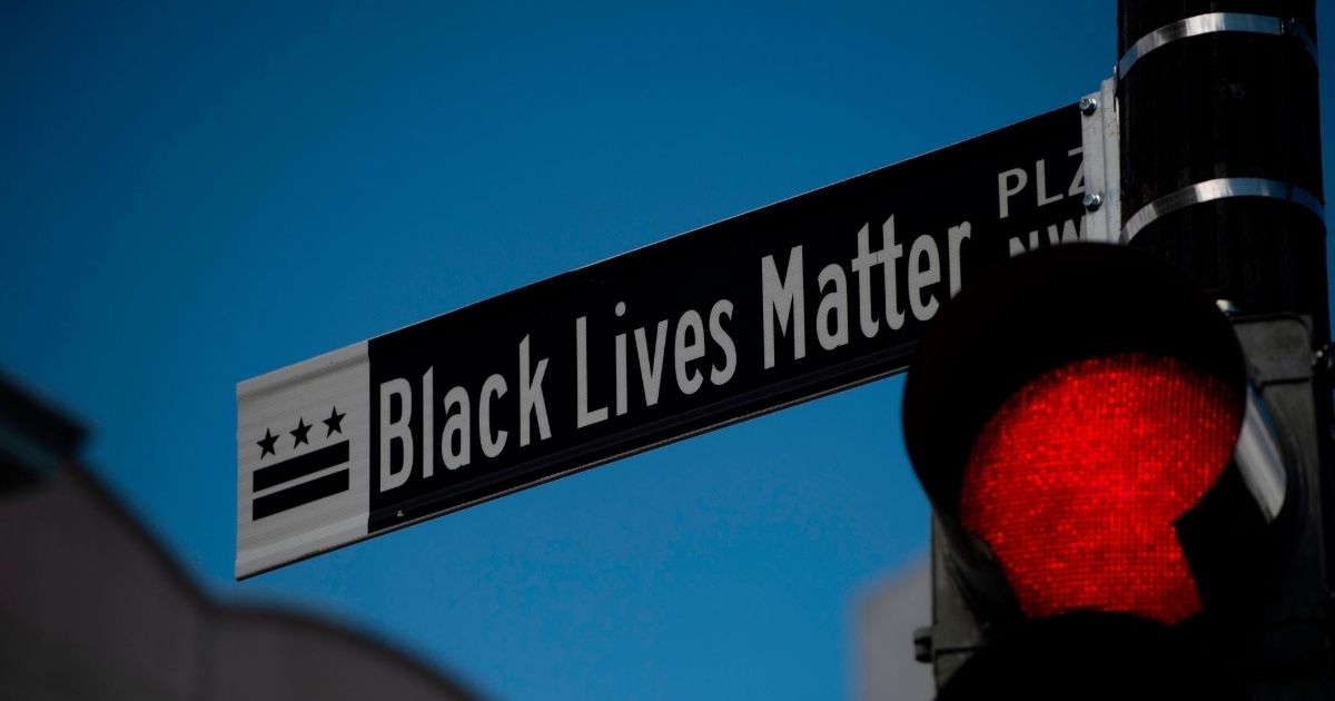 A new street sign that reads "Black Lives Matter Plaza NW" can be seen at the intersection of H and 16th Street near the White House in Washington, D.C., on June 5, 2020.