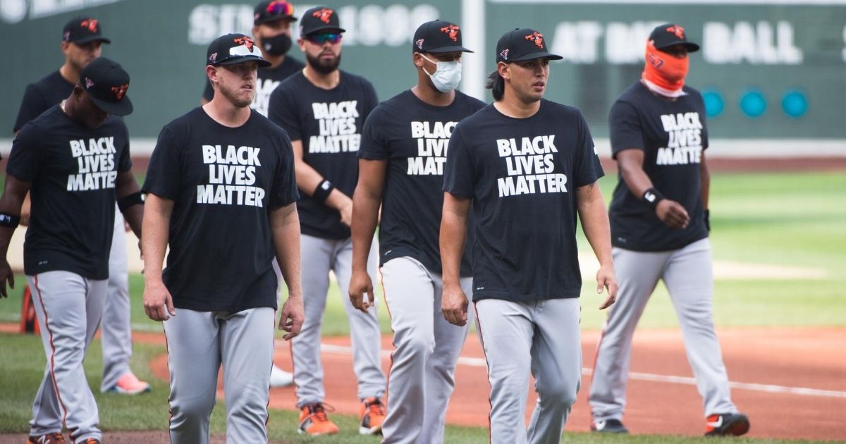 Members of the Baltimore Orioles wear Black Lives Matter T-shirts during batting practice prior to the start of the game against the Boston Red Sox on Opening Day at Fenway Park on July 24, 2020, in Boston.