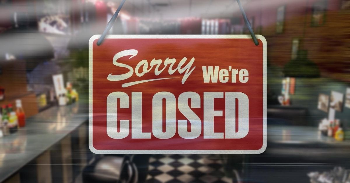 A stock image of a sign on a restaurant window reading "Sorry, we're closed" is pictured above.