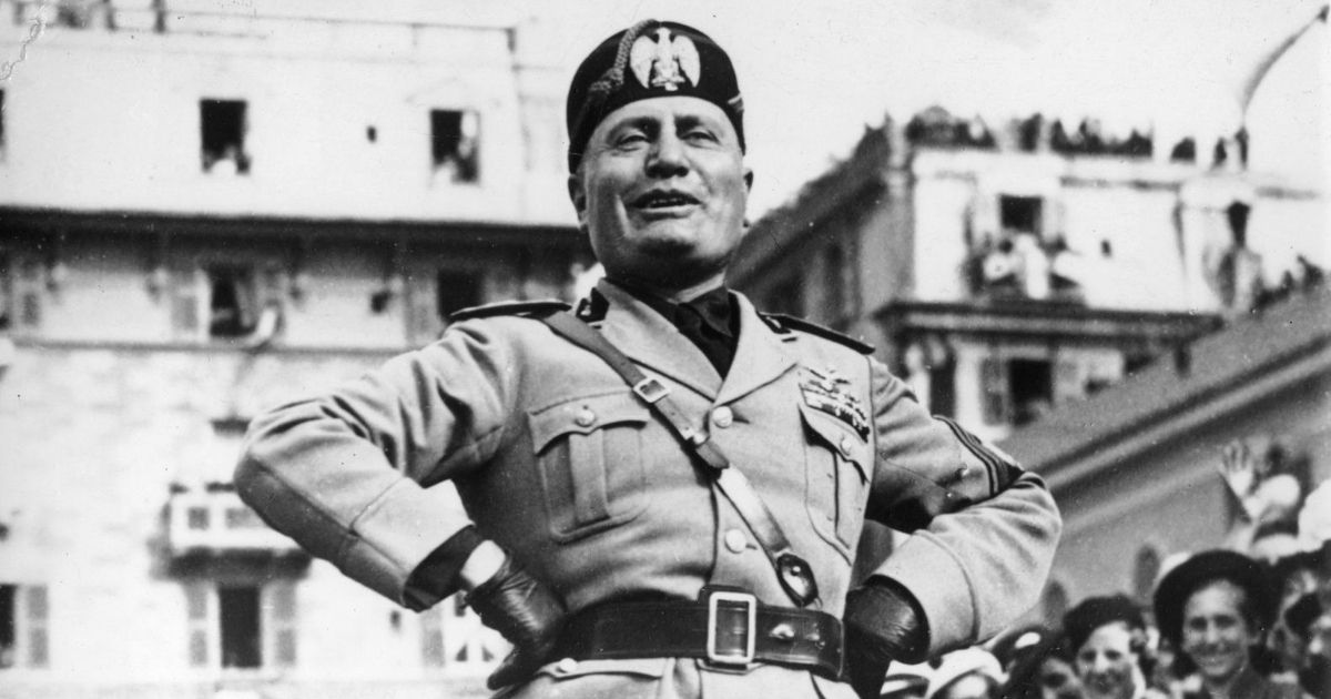 Italian dictator Benito Mussolini stands on a platform while addressing the workmen of a munitions factory in Genoa, Italy, on May 8, 1938.