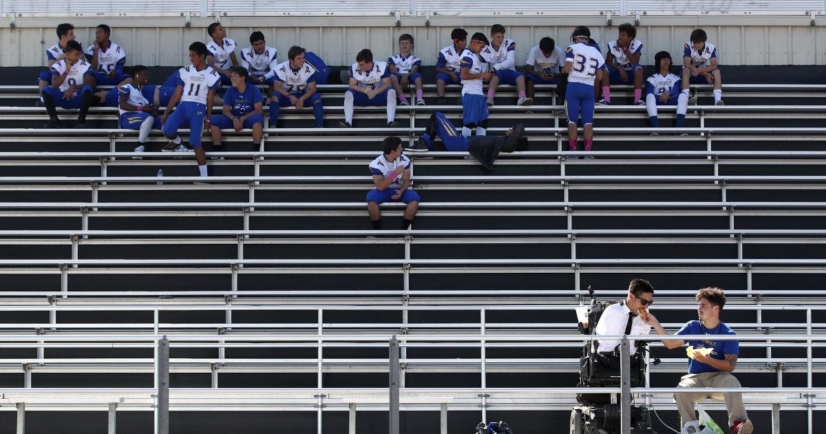 High school football players gather in the stands in San Jose, California, on Oct. 19, 2018. A coach in Chattanooga, Tennessee, is urging a return to normalcy amid the COVID-19 pandemic.